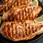 Grilled Chicken stacked on a plate.