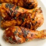 Grilled BBG Chicken Legs placed on a platter.