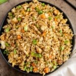 savory chicken fried rice with vegetables in a black bowl