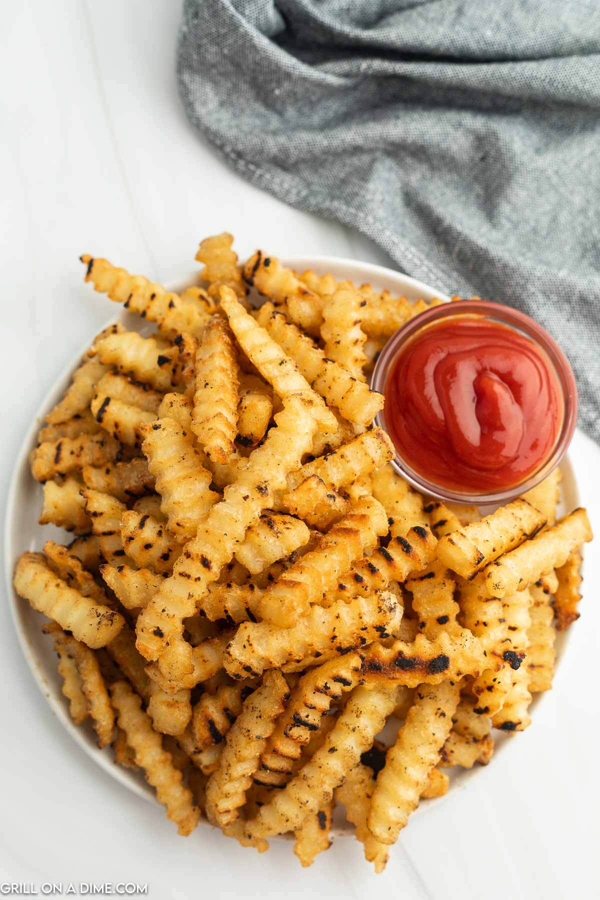 Blackstone French Fries on a plate with a side of ketchup