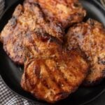 Grilled Pork Chops covered in BBQ Sauce on a plate
