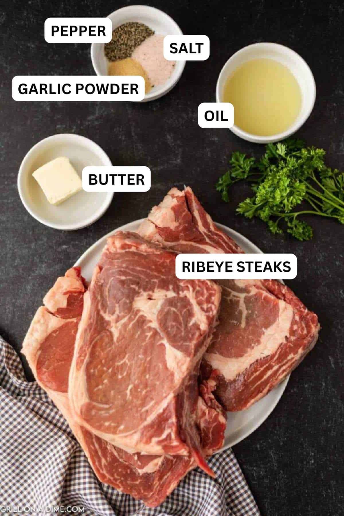 Ingredients needed to make this recipe includes ribeye steaks, salt and pepper, garlic powder, oil, and butter.