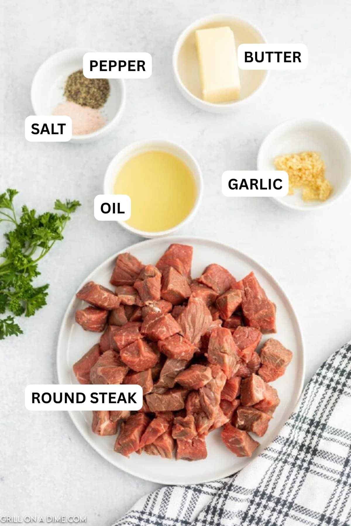 Ingredients needed to make this recipe which includes round steak, oil, minced garlic, salt, pepper, and butter.