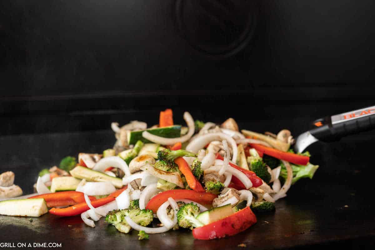 Cooking the vegetables on the griddle.
