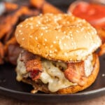 A bacon cheeseburger with sweet potato fries.