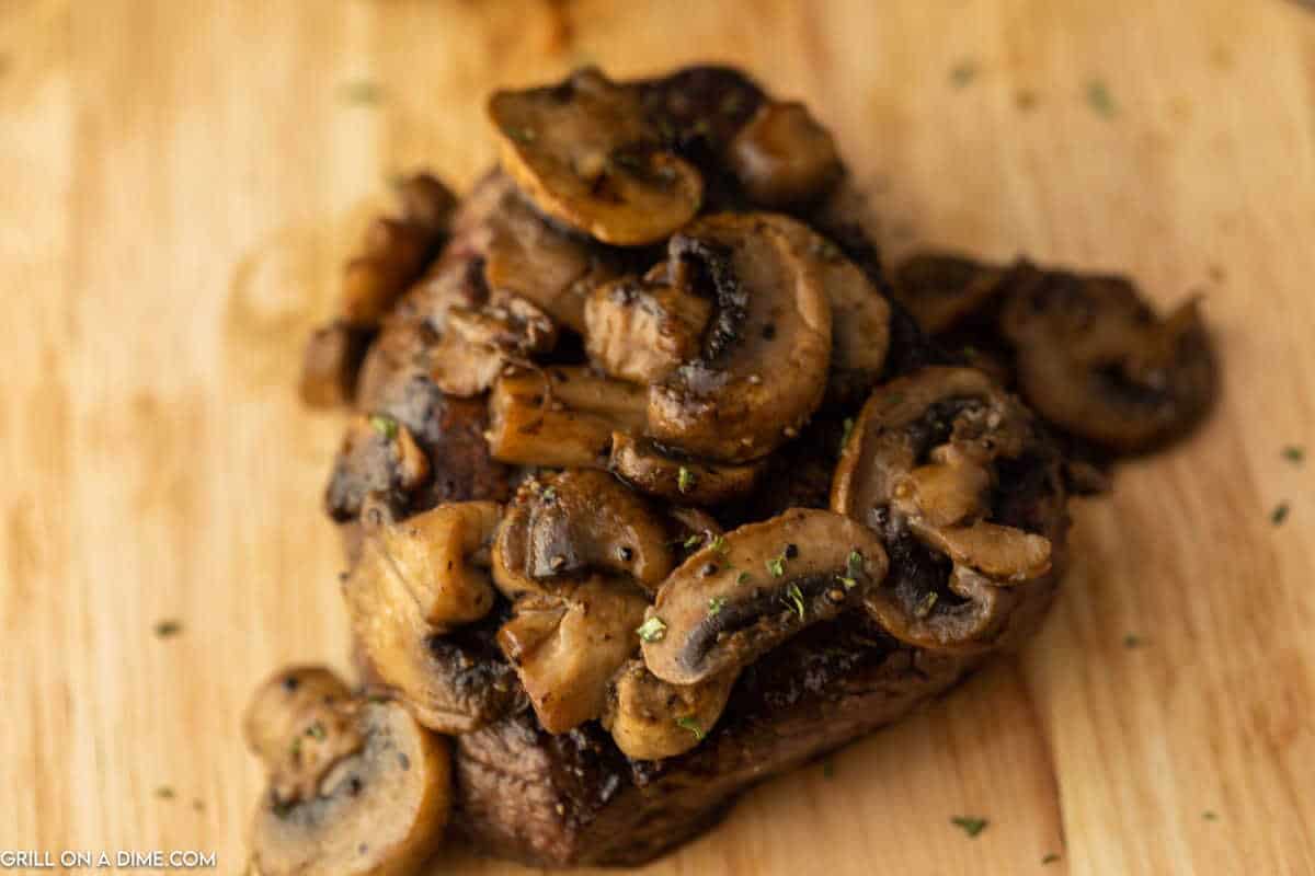Sirloin Steak with mushrooms on the top.
