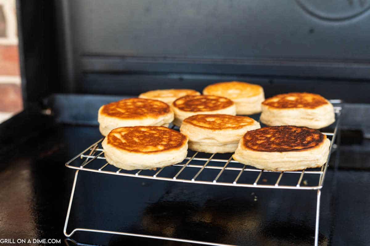 Biscuits on a wire rack on the griddle.