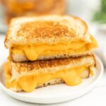 Golden grilled cheese sandwich with melted cheese ooze. Perfect comfort food made easy at home.