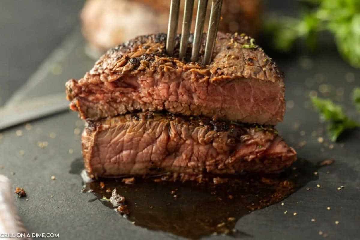 Grilled Sirloin Steak stacked with a fork. 
