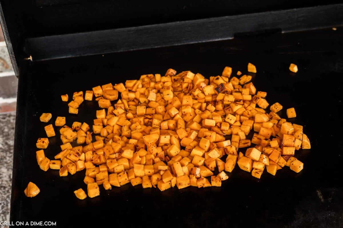 Diced sweet potatoes on a griddle.