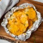 Slice potatoes topped with melted cheese foil