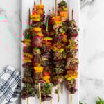 A platter of skewers with vegetables and meat.