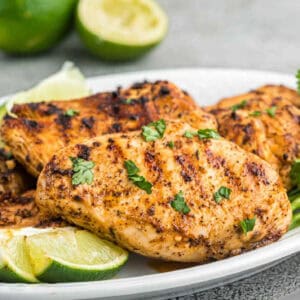 Grilled Chicken Breast stacked on a plate.