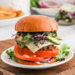 California Burger layered with slice tomatoes, lettuce, pickles and slice cheese
