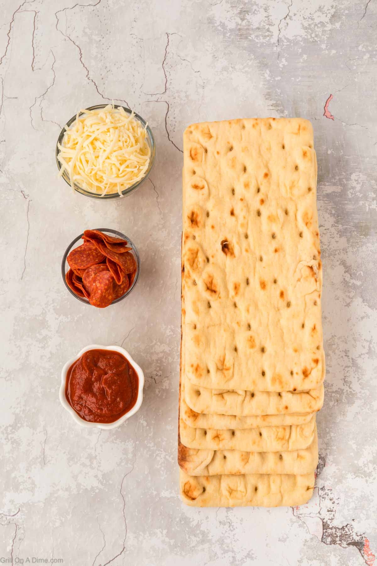 Ingredients - Flatbread, pizza sauce, slice pepperonis, shredded cheese