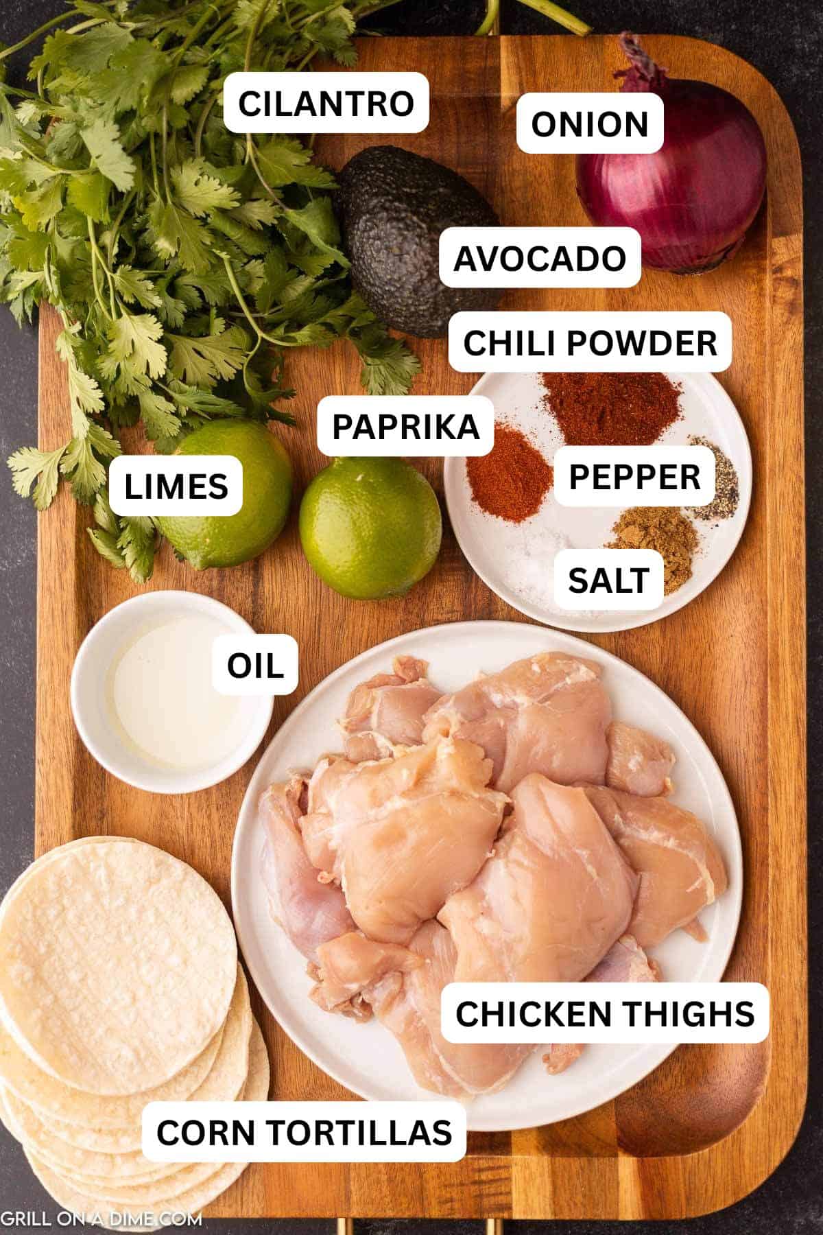 Ingredients needed to make chicken street tacos chili powder, chicken thighs, corn tortillas, lime, olive oil, paprika, salt, pepper, fresh cilantro.