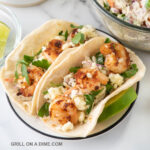 Fresh shrimp tacos with crumbled queso fresco, cilantro, and grilled corn tortillas. Perfect for a quick, flavorful meal.