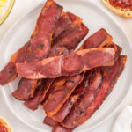Cooked Turkey Bacon stacked on a plate