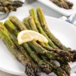 Grilled asparagus with lemon wedges.
