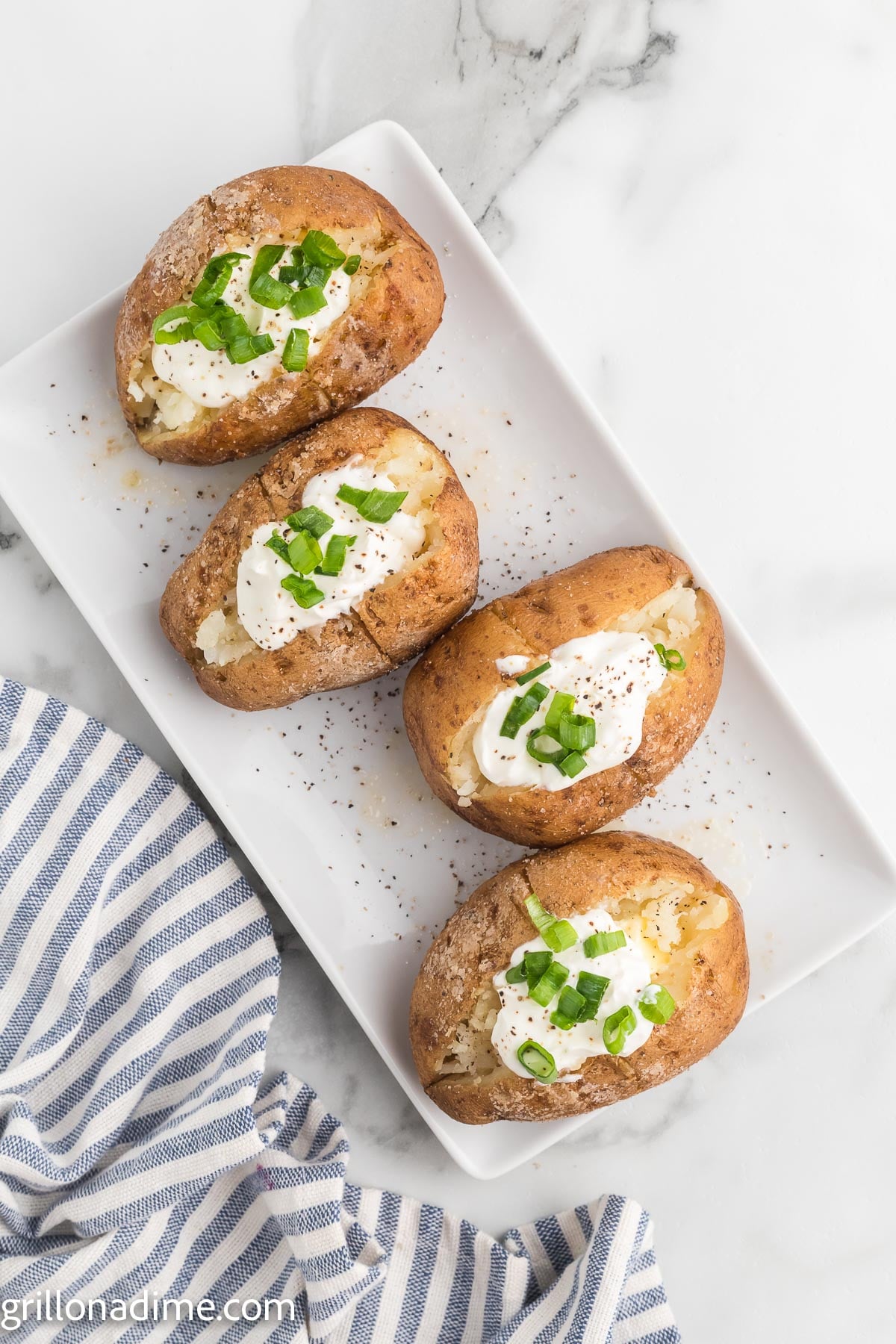Smoked baked potato topped with sour cream and chives