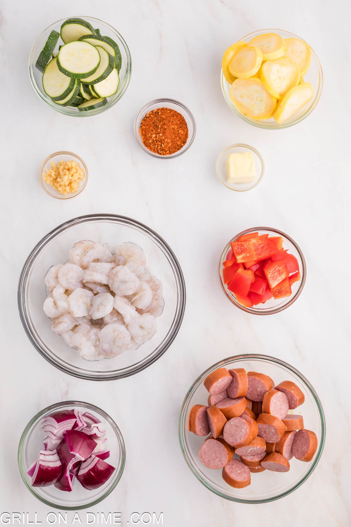 Ingredients needed - Shrimp, sausage, zucchini, squash, red bell pepper, red onion, minced garlic, cajun seasoning, butter