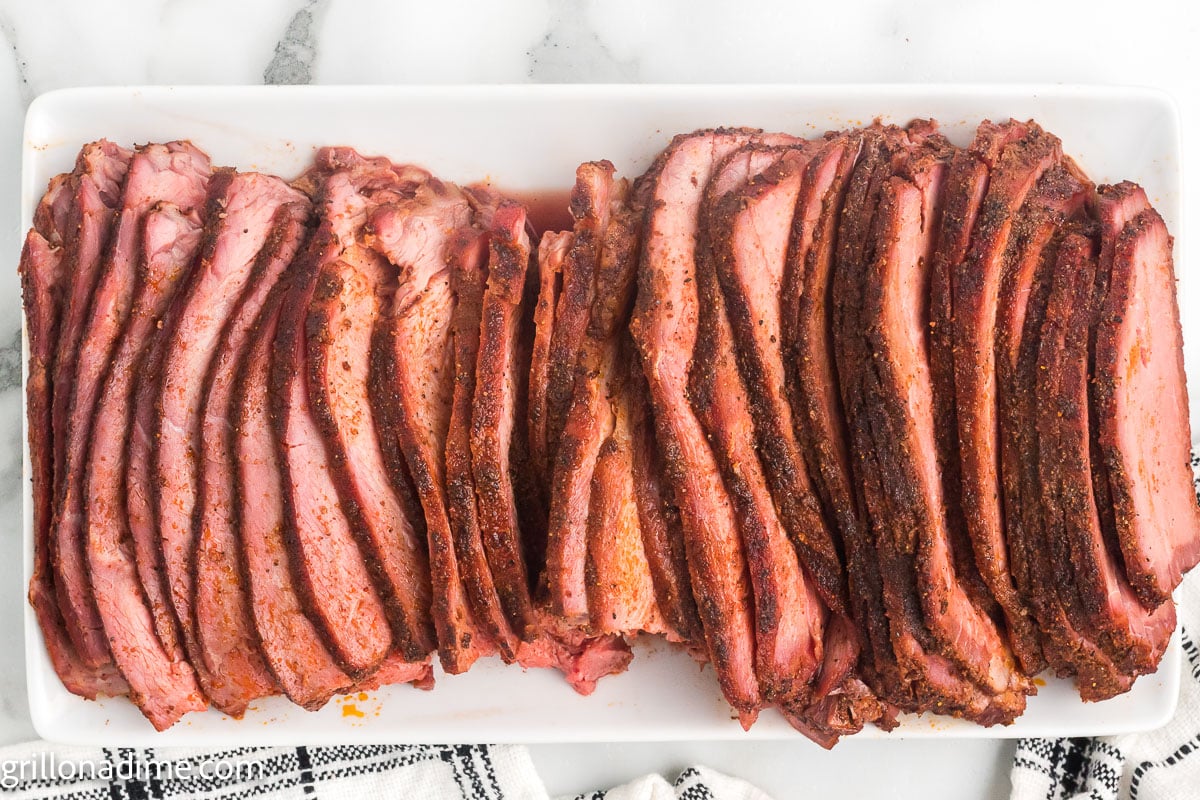 Sliced beef roast on a white platter