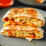 Two breakfast crunchwrap stacked on top of each other.