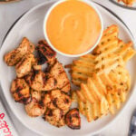 Grilled Chicken Nuggets on a plate with waffle french fries