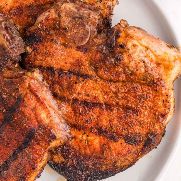 Seasoned pork chops on a white plate