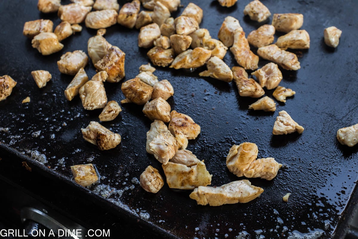 cooked diced chicken on the blackstone griddle