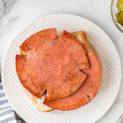 Cooked Bologna stacked on a plate