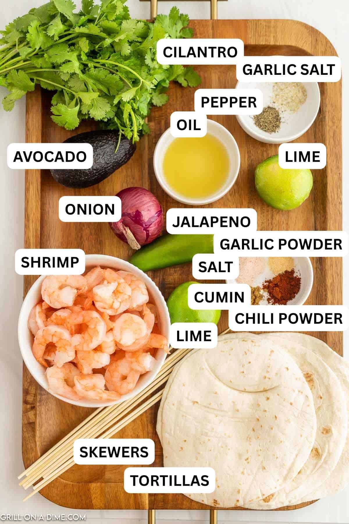 Ingredients needed to make this recipe which includes shrimp, oil, tortillas, lime, red onion, avocado, cilantro and spices. 