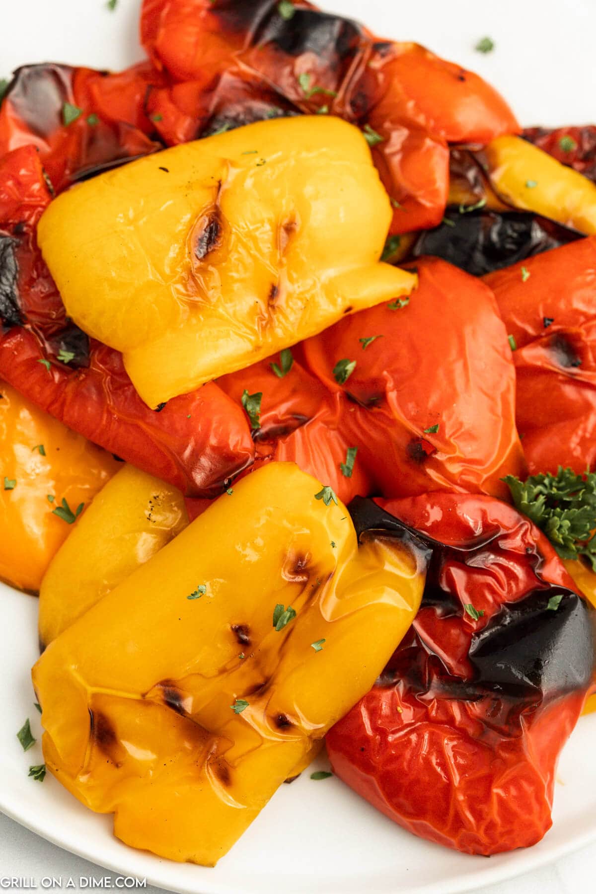 Yellow, orange and red sliced bell peppers with a charred texture