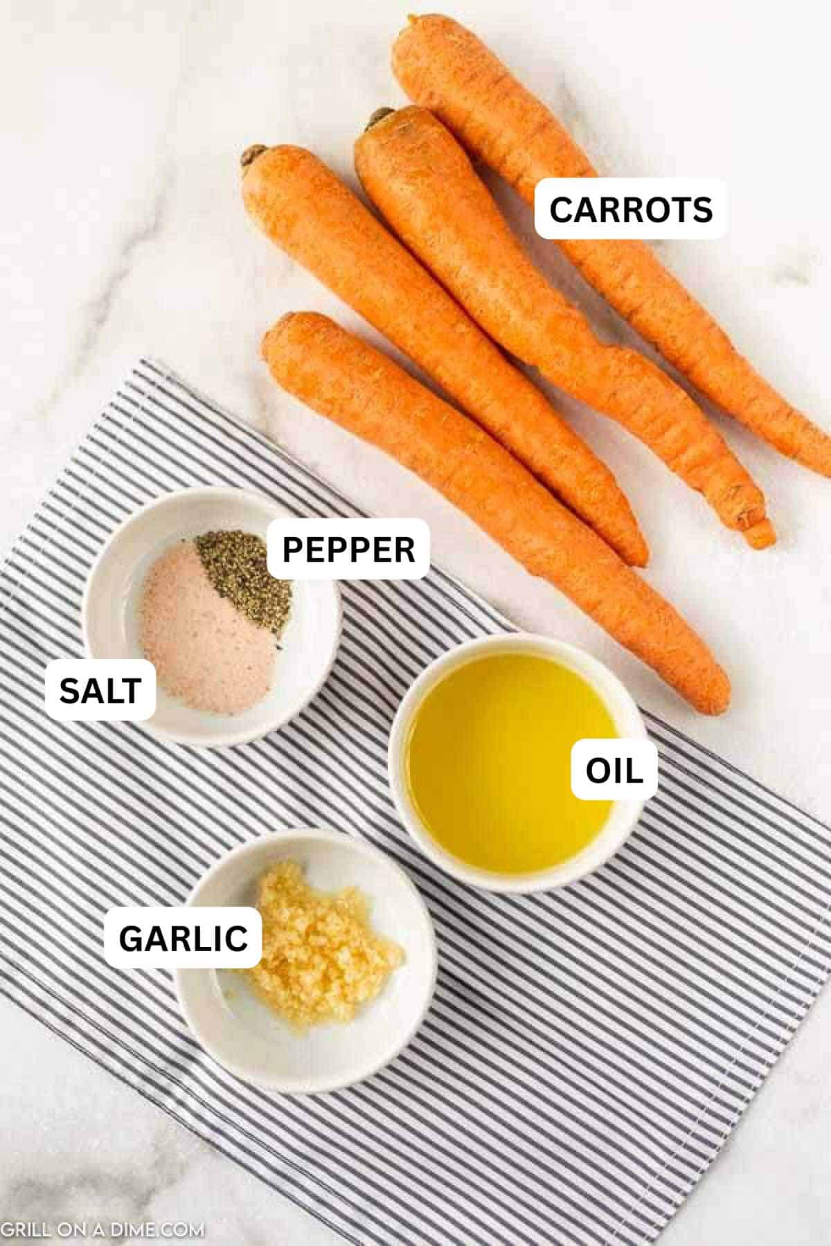Ingredients to make this recipe which includes raw carrots, salt, pepper, oil and minced garlic. 