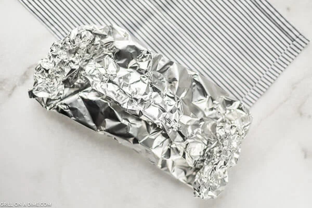 Foil Packet on a marble table with a strip towel next to it. 