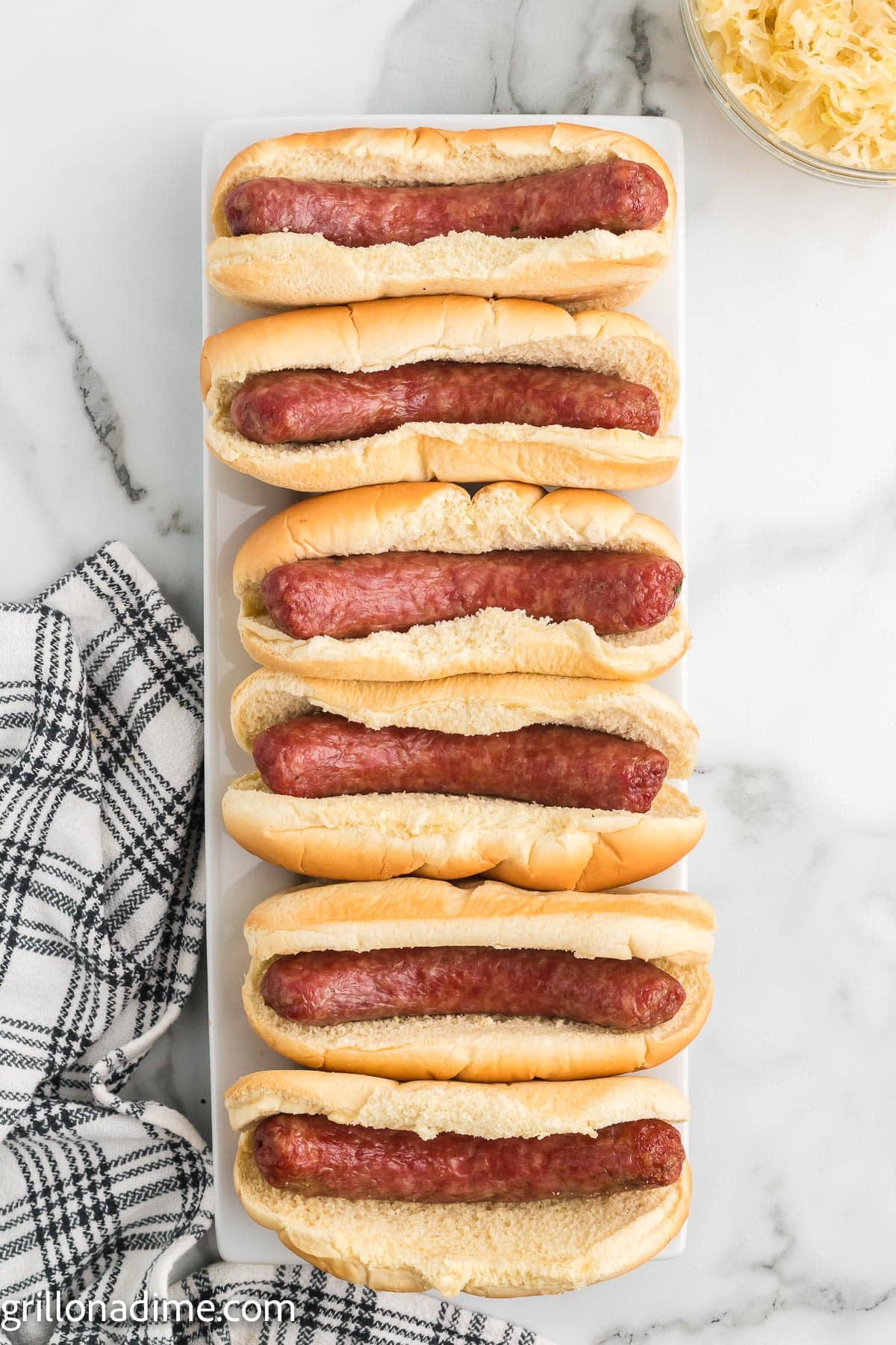 Brats in Hot Dog Buns on a platter