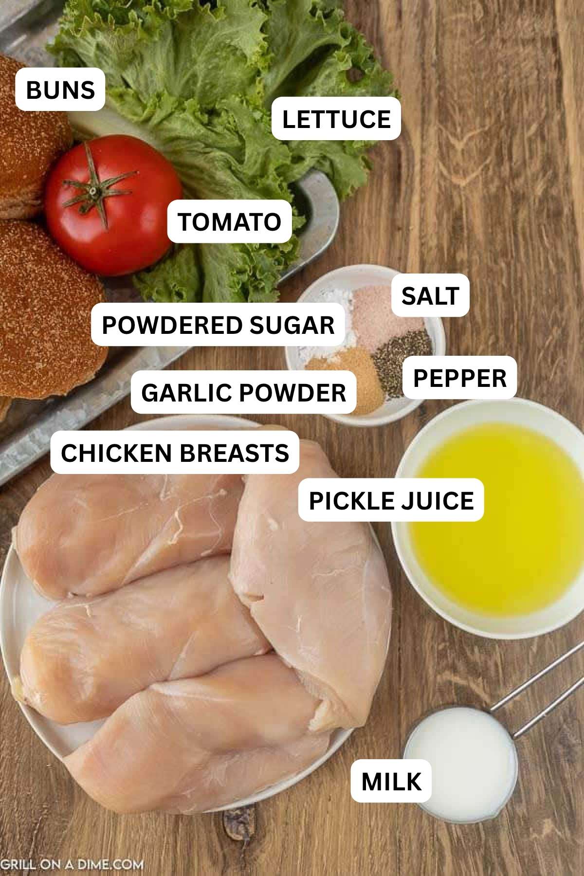 Ingredients needed to make this recipe which includes Chicken, pickle juice, milk, powdered sugar, pepper salt, garlic powder, olive oil, lettuce, tomato, buns, and dressing.