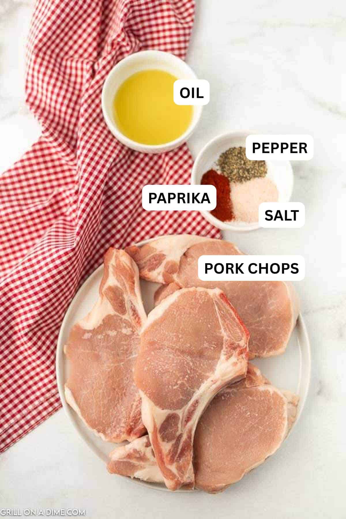 Ingredients needed need to make this recipe which includes bone-in pork chops, olive oil, paprika, salt and pepper. 