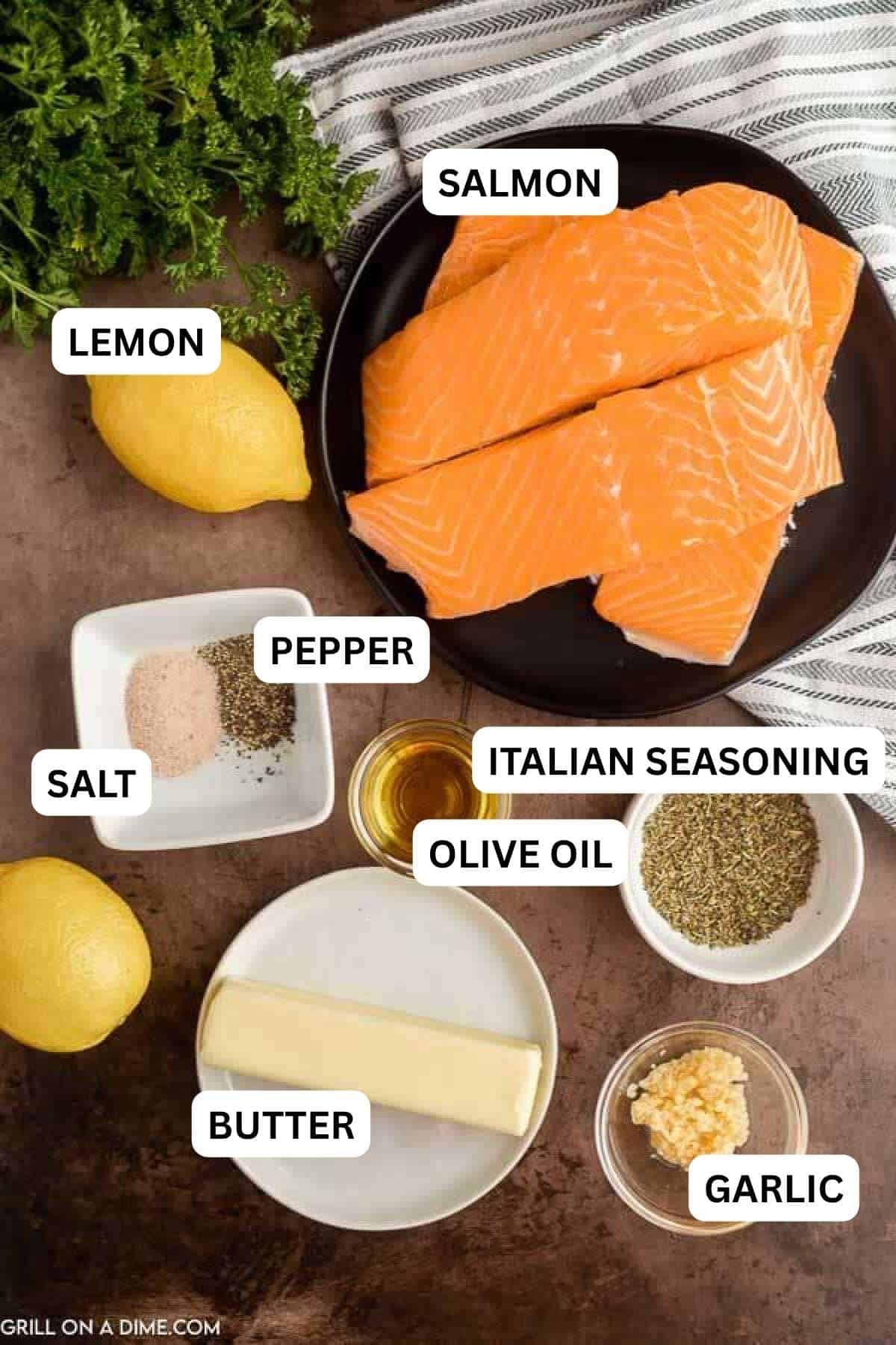 Ingredients to make this recipe which includes salmon, lemon, spices, garlic and butter. 