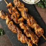 Grilled Chicken on skewers on a black slate board