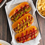 Grilled Hot Dogs on a parchment paper lined pan