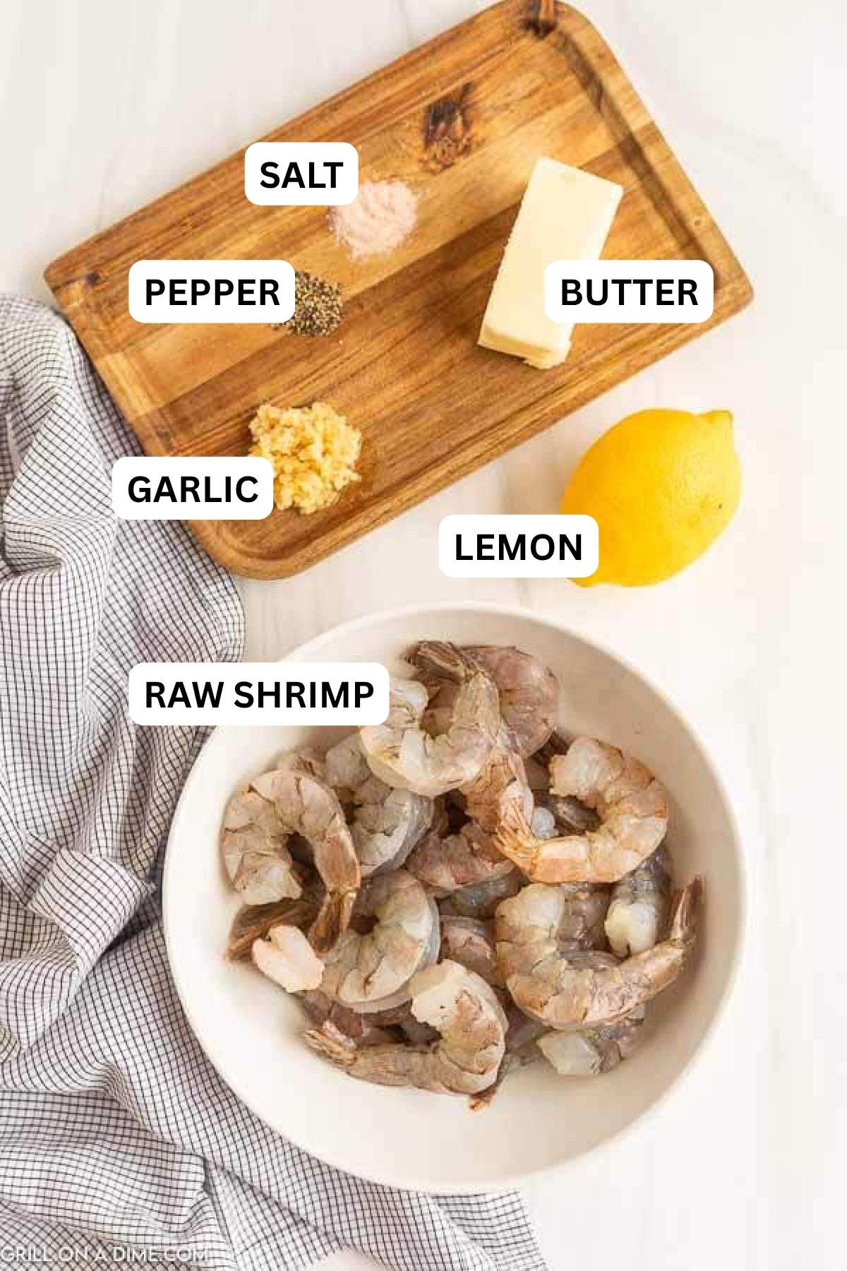 Ingredients need to make this recipe which includes raw shrimp, butter, minced garlic, salt, pepper, and lemon.