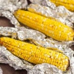 Corn on the Cob placed on a top of aluminum foil.