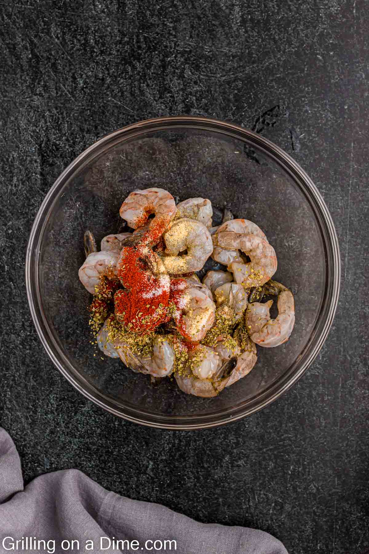 Mixing the seasoning with the shrimp in a bowl