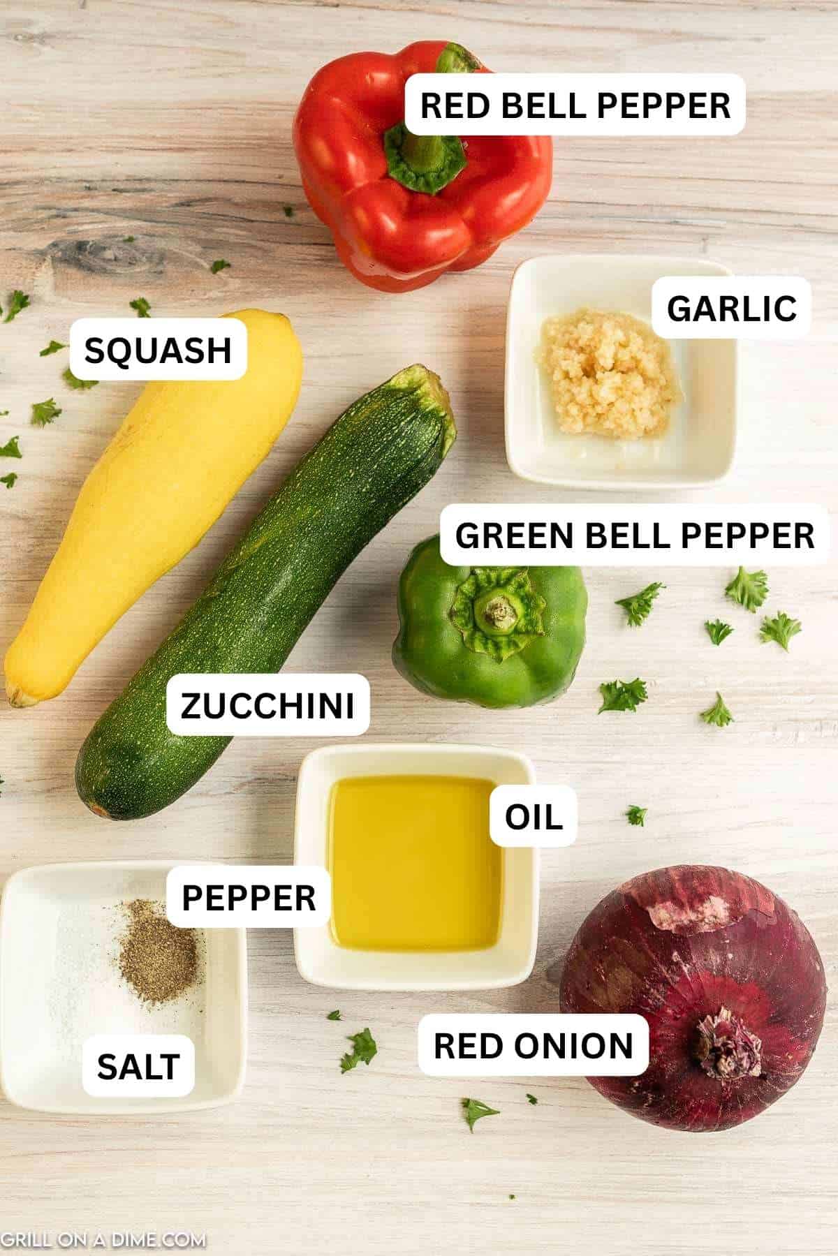 Ingredients needed to make this recipe which includes zucchini, squash, onion, bell pepper, salt and pepper, minced garlic, and olive oil.