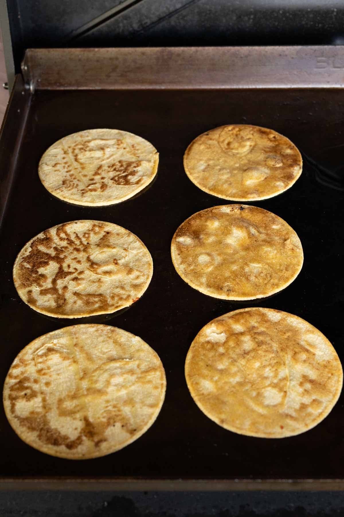 Browning the corn tortillas on the Blackstone