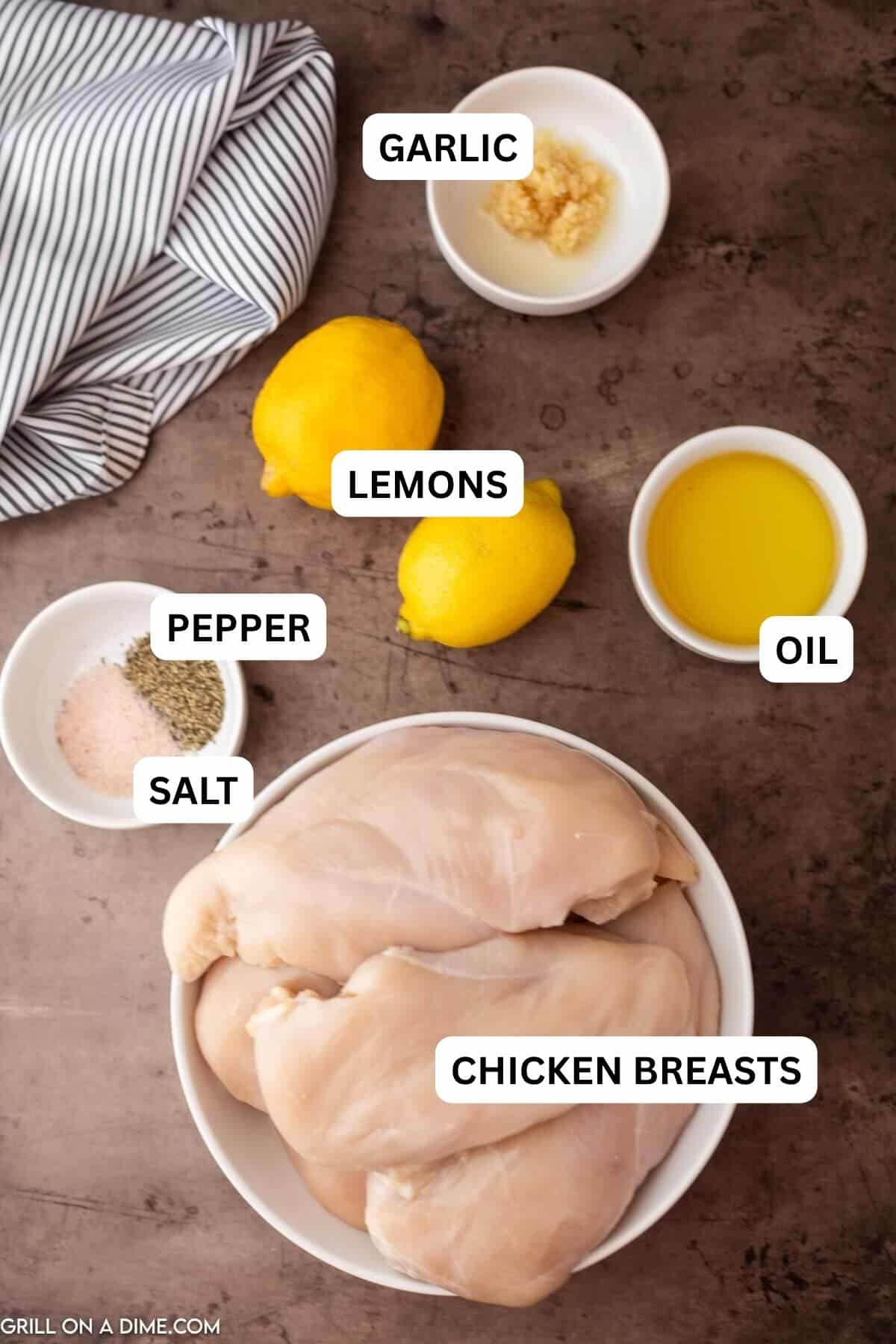 Ingredients needed to make this recipe which includes chicken breast, olive oil, minced garlic, black pepper and salt, and lemons.