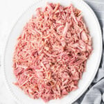 A plate of shredded beef on a white background.