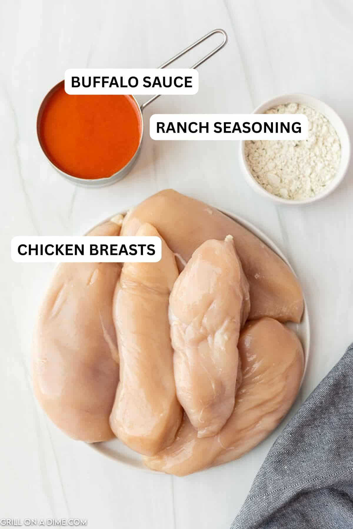 Ingredients needed to make this recipe which includes chicken breasts, buffalo hot sauce, and ranch seasoning mix.