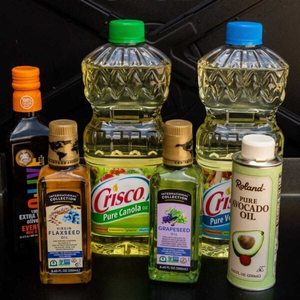 Various oils and other products are shown on a counter.
